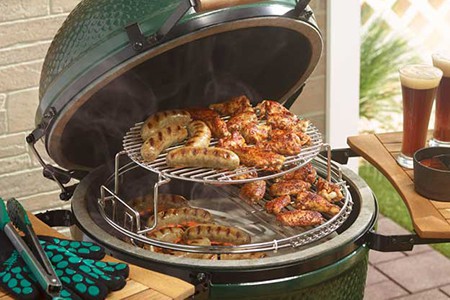 Food being laid out on a big green egg grill