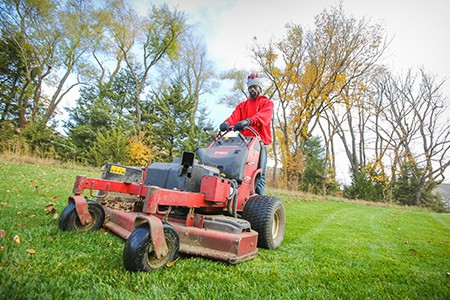 TenderCare employee mowing the lawn